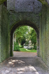 Main gate in conserved ruins of medieval stone castle from 12th century in town of Maynooth in Ireland.