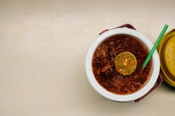 Lemon tea in water canteen on old white wooden background