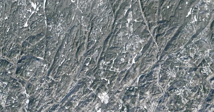 Very high-altitude overflight aerial of woodland in Quebec, Canada, in winter. Clip loops and is reversible. Elements of this image furnished by USGS/NASA Landsat