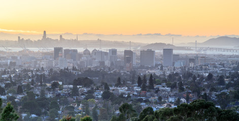 Sunset over Oakland and San Francisco Hazy Skylines. Oakland Hills, Alameda County, California, USA.
