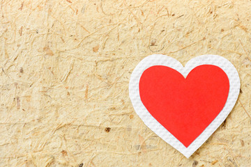 Big red and white heart paper on brown paper background. LOVE and valentines day concept.