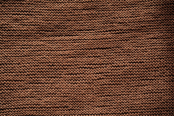 Brown knitted wool texture background pattern horizontal background. Selective focus. Top view. Copy space.