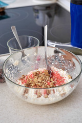 Mixing the cottage cheese and ingredients for making dietary of dessert, close-up.