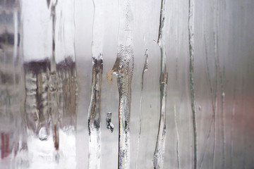 Misted glass Windows with icy potted streams. Conceptual view of the house from the outside.