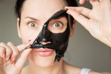 a girl in a black coal mask
