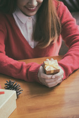 Giving a gift Girl holding gift box of christmas present.