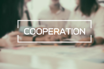 Cooperation Business word on meeting of business on blur background.