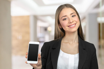 Happy pretty woman showing a blank smart phone screen