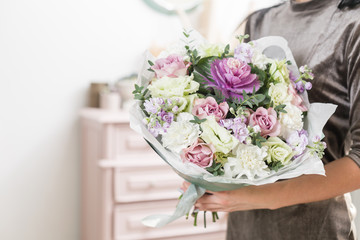 beautiful luxury bouquet of mixed flowers in woman hand. the work of the florist at a flower shop.