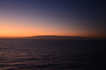 Fototapeta na wymiar Travelling from Tenerife to La Gomera in the twilight with a ferry, view to the island La Gomera
