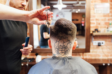 man getting trendy haircut at barber shop.