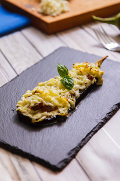 Baked eggplant with mushrooms and cheese on slate
