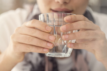 Young woman drinking glass of water