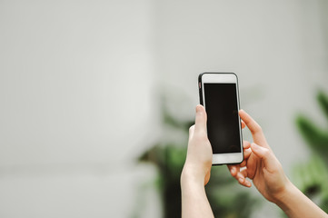 Mobile phone is in the hands of that person.