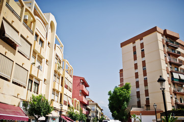 Naklejka premium Streets with architecture of the resort town buildings and tropical greenery.
