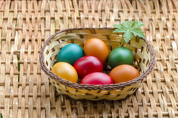 Closeup paint Easter eggs in the basket on wicker table, Sofia, Bulgaria  