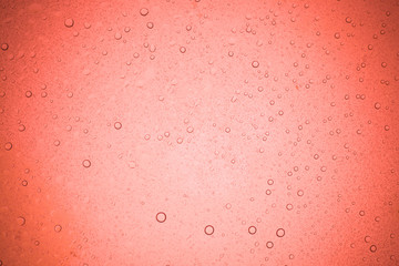 Rain droplets on red glass background, Water drops on glass.