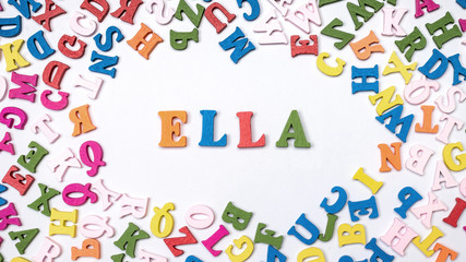 Baby name ELLA composed of wooden letters on floor. Choosing name concept