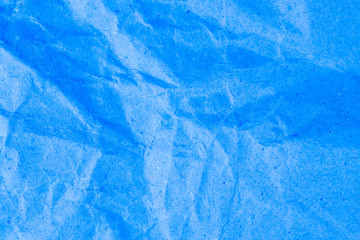 Blue vignette crumpled paper.
