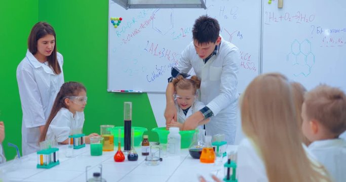 Teacher showing experiment how fire burning on their hands. Teacher explaining an experiment to a high school chemistry class together