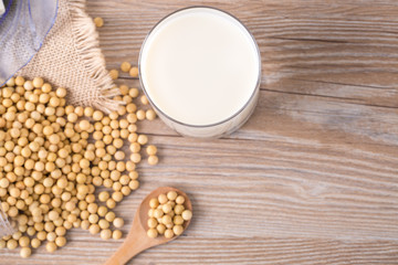 Top view of soybeans and soy milk in a glass on table
