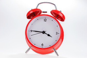 Old red retro alarm clock isolated