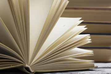 Open book, hardback books on wooden table. Back to school. Copy space
