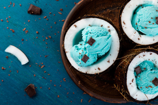 Blue ice cream in coconut bowl.