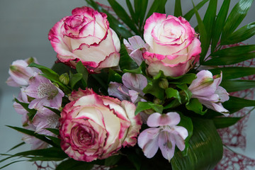 A wonderful bouquet of white roses with red flowers and spring flowers