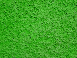 Obraz na płótnie Canvas Сoncrete of green plastered wall. Green salad plastered wall texture grunge background. Beautiful decorative green plastered wall or cyan painted stucco. Green plastered wall as handmade rough paper
