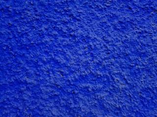 Сoncrete dark blue plastered wall. Dark blue plastered wall texture grunge background. Beautiful decorative navy blue plastered wall or cyan painted stucco. Blue plastered wall as handmade rough paper