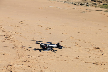 Drone landed on the beach sand