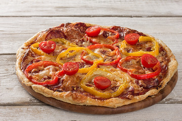 Delicious pizza served on wooden plate 