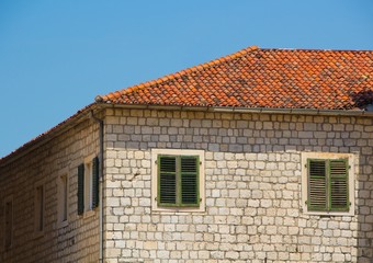 Old brick house with a tiled roof. The old town of Kotor, Montenegro.