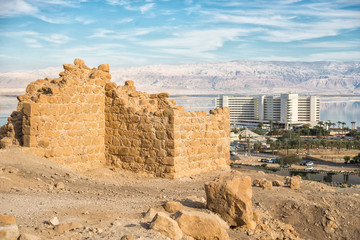 The ruins of the ancient city wall against the backdrop of the sea and the modern city