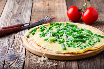 Egg omelette filling with grated cheese and green vegetables