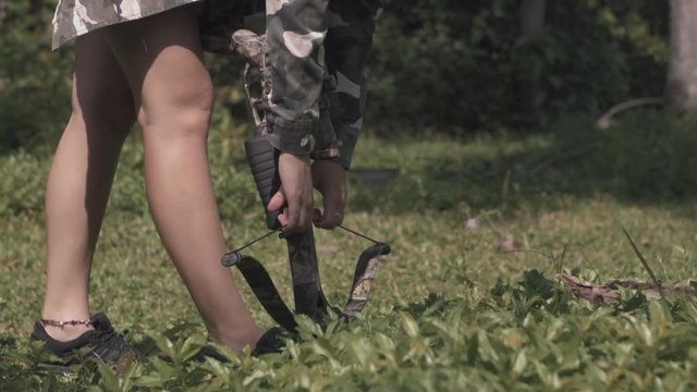 3 in 1 video. blonde in camo jacket is shooting from a crossbow slow motion