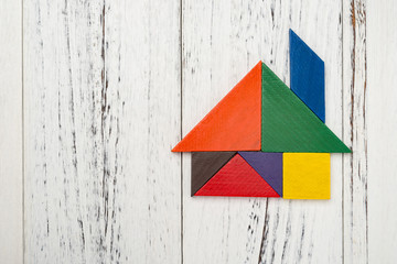 wooden tangram shaped like a house with copy space