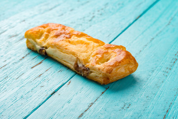 side view studio shoot of sweet red bean pastry on wood background
