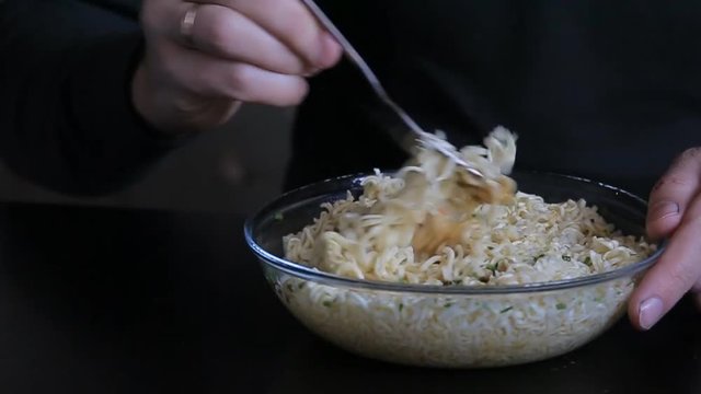 bearded man eating instant noodles