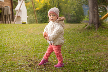 Small child girl playing outdoors