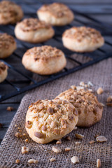 Peanut butter cookies on a burlap cloth with cookies on a cooling rack of in background