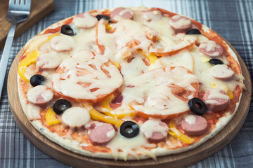 delicious homemade pizza on the table. Grated cheese and olives Menu, restaurant recipe concept.