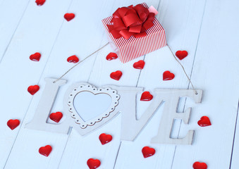gift box and the word love on a light background.
