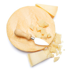 Whole round Head and pieces of parmesan or parmigiano hard cheese