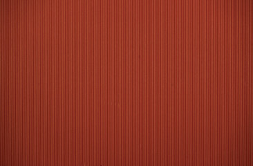 Dark red colored colored corrugated cardboard texture useful as a background