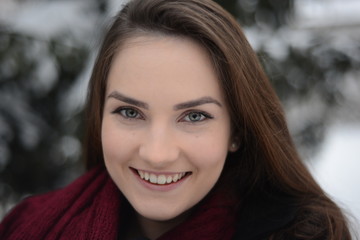 Cheerful girl smiling in winter park