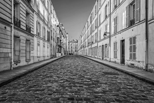 Fototapeta Picturesque cobbled street in Paris, France
