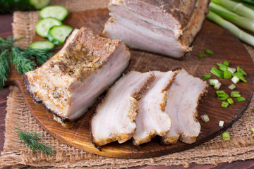 Ukrainian traditional food - salo. Sliced bacon with onion on wooden background