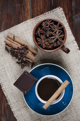Coffee with ansie and cinnamon on table